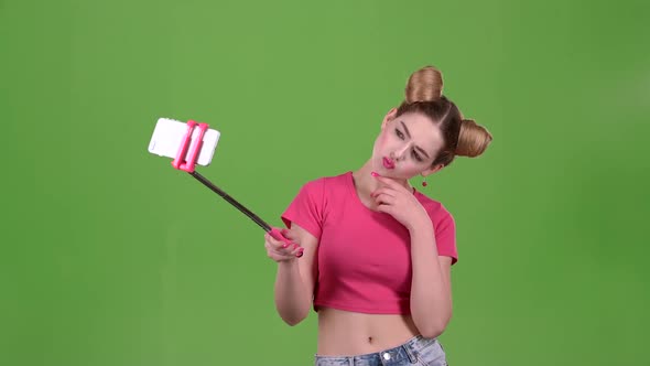 Teen Doing Selfie on Selfie Stick. Green Screen