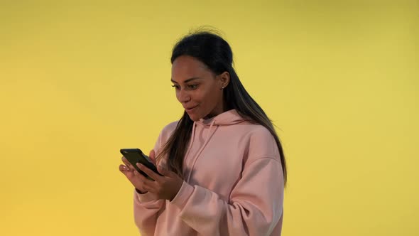 Pretty Black Woman Finding Something Incredible Surfing the Internet on Smartphone