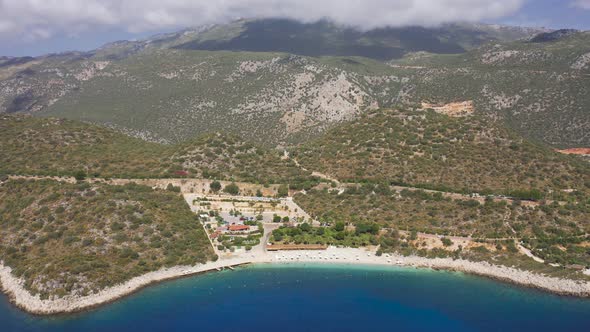 White Sand Belediyesi Beach and Turquoise Sea Against the Backdrop of High Mountains in the Clouds