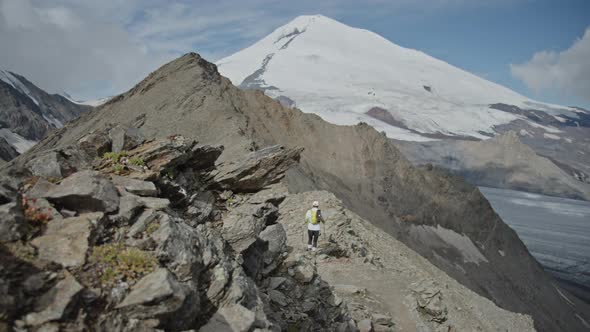 Man Walking on a Ridge in a Big Mountains Mt