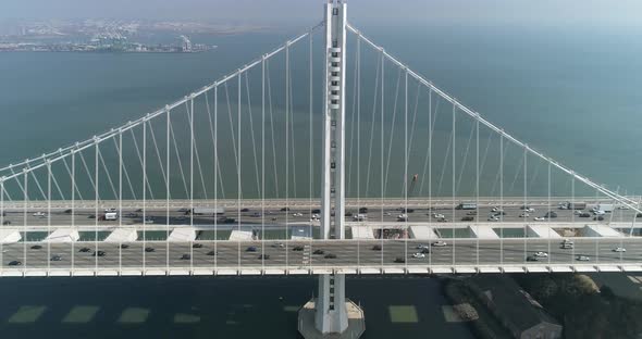 Aerial shot of vehicles moving on San Francisco–Oakland Bay Bridge with city in background