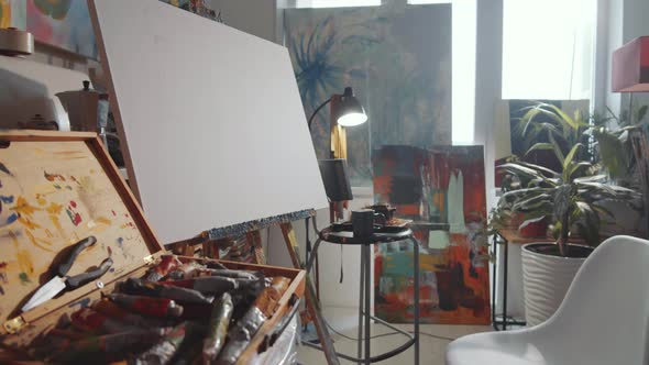 Creative Art Studio with Easel, Paintings and Tools