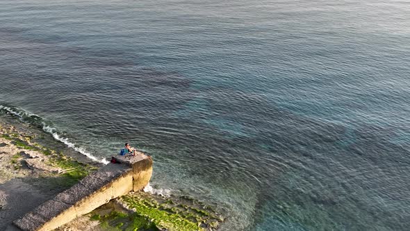 A fisherman catches fish in the sea aerial view 4 K