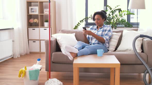 Woman with Smartphone Resting After Home Cleaning 30