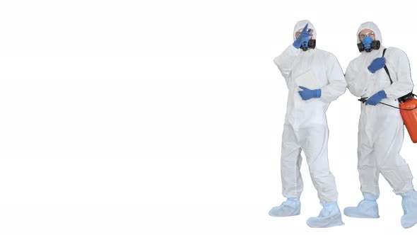 Anti Coronavirus Disinfection Team of Virologists in Hazmat Suits Making Plan of Disinfection on