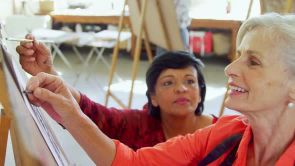 Drawing teacher assisting woman in drawing sketch 4k