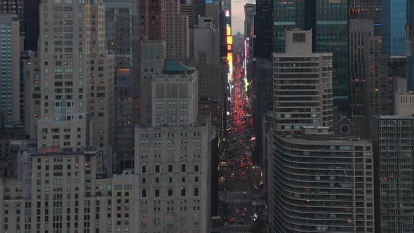 AERIAL: View of 7Th Avenue Traffic and Times Square Over New York City Central Park at Sunset with