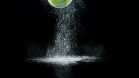 Bouncing ball with powder against black background