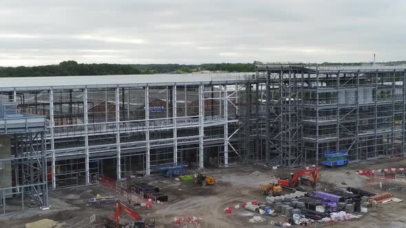 Aerial view descent over empty modern concrete office building construction site