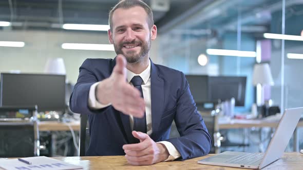 Cheerful Young Businessman Offer Shaking Hand in Office