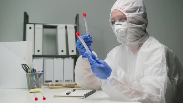 PCR Test in Laboratory Doctor Holding COVID19 Coronavirus Swab Collection Kit Wearing PPE Protective