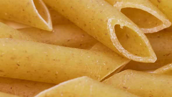 Wheat pasta, macro shot in 4k. Rotating motion, view from above. Close up shot.