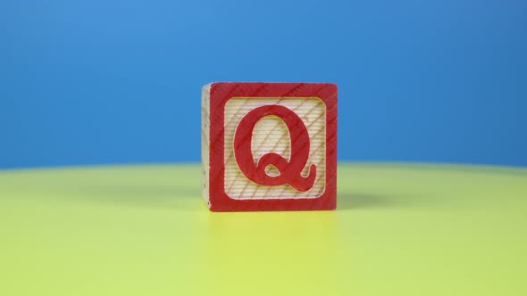 Close up shot letter "Q" alphabet wooden block