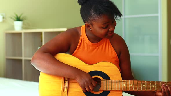 Latin Hispanic Woman Learning to Play on Guitar