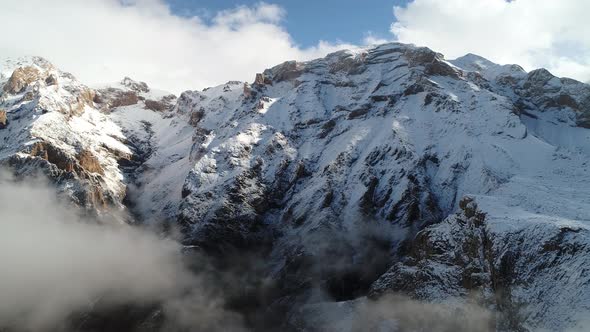 Rocky Foggy Mountain Peak In Snowy