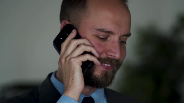 Bearded male looks into camera and smiles with confidence