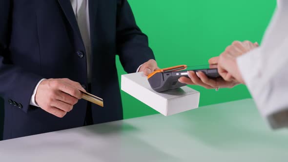 Businessman in a Suit Makes a Payment with Credit Card NFC Terminal Contactless Payment for