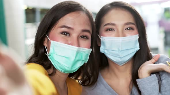 Asian woman wearing face mask. Happy woman with shopping bags