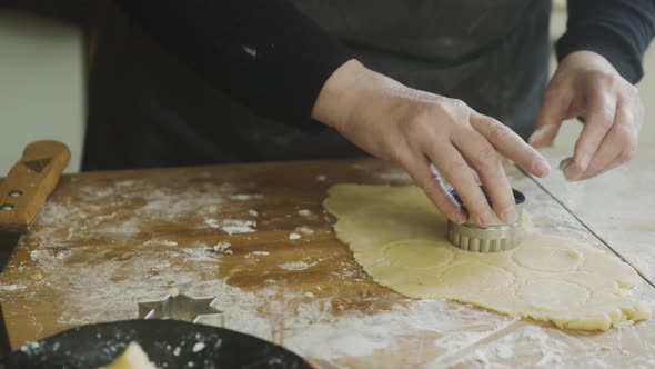 Woman making filled Christmas cookies