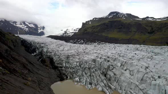 Iceland glacier with mountains close up with drone video moving forward.