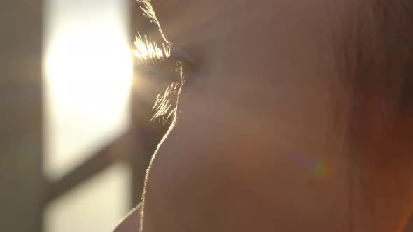 Extreme Close Up of Woman Opening Beautiful Eye with Blue Iris