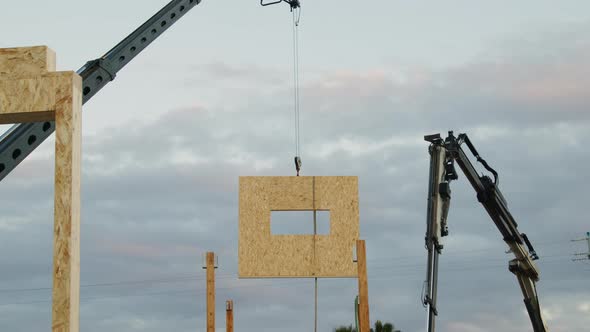 Crane Lifts Wooden Wall in the Air