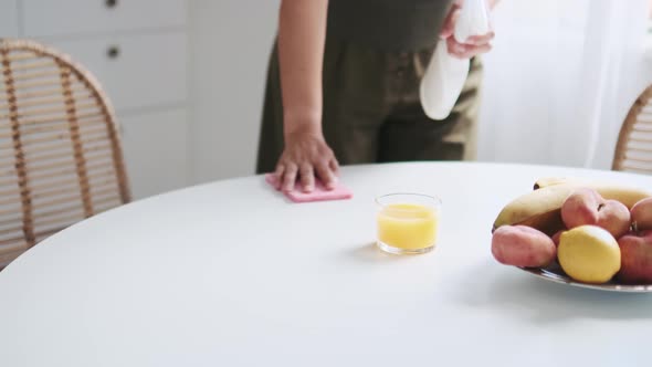 Woman hands wiping the dining table