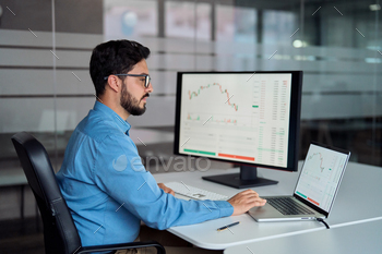 Busy business man broker analyst investor using laptop analyzing stock market.