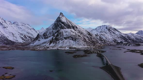 Fredvang Bridge and Volandstind Mountain in Winter. Lofoten, Norway. Aerial View