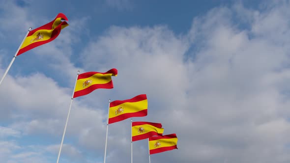 Waving Flags Of The spain blue sky