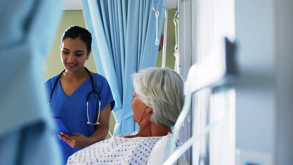 Senior patient being checked by female doctor in the ward