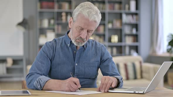 Old Man Writing Letter in Office