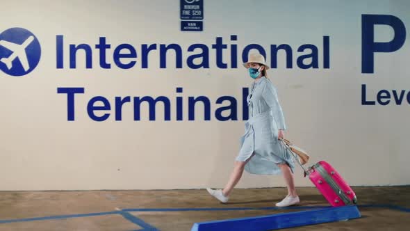 Slow Motion of Woman Walking with International Terminal Signage on Background