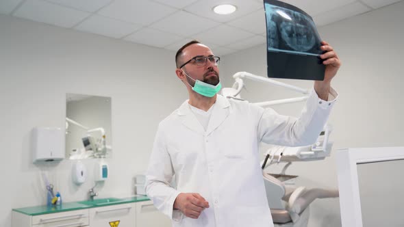 Dentist examining a x-ray image