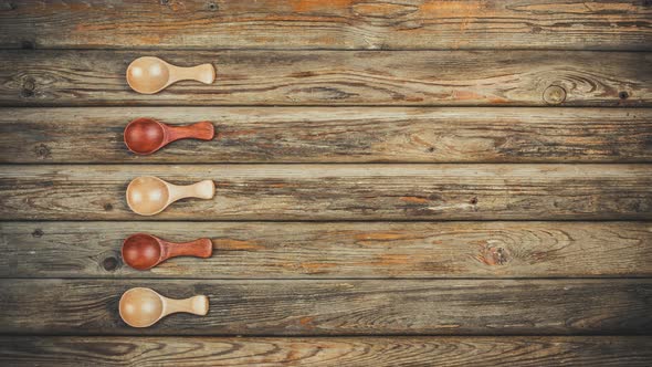 Wooden Spoons Move And Fill With Spices On The Table