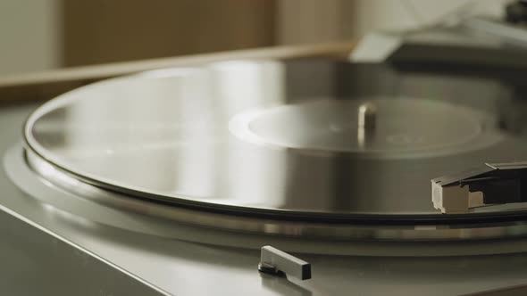 Playhead Moves Into Place Starting Playback on a Vinyl Table at Home Indoors