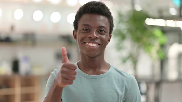 Positive Young African Man Doing Thumbs Up 