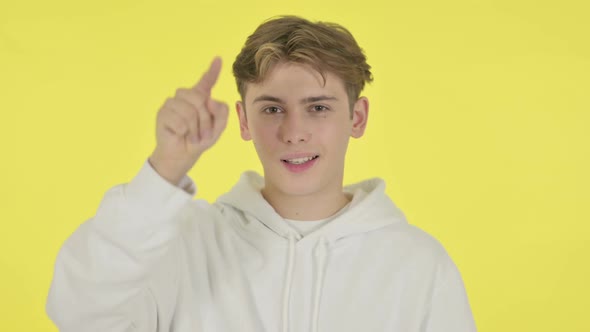 Young Man Pointing at the Camera on Yellow Background