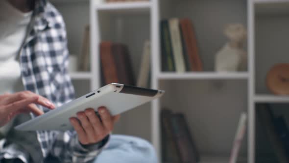 Girl Teenager Student Types The Text On The Tablet A Young Girl Is Sitting On The Floor With