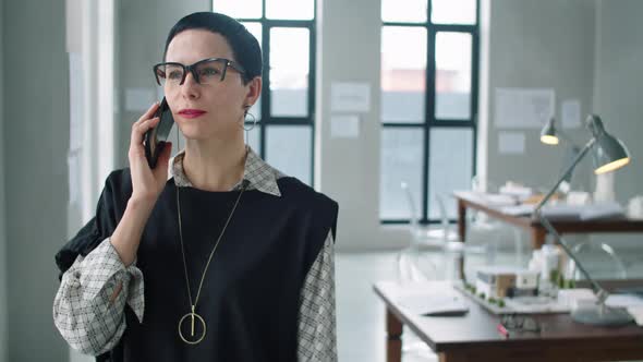 Beautiful Middle Age Businesswoman Speaking on Phone in Office