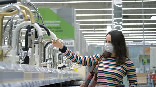 Woman in Safety Mask Choosing Water Tap in Store