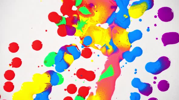 top view  of colorful of oil paints dripping to white paper.