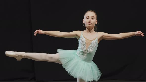 Little Ballerina Girl Child Teenager in Tutu Doing Ballet Pose Position Effort Balance on One Leg