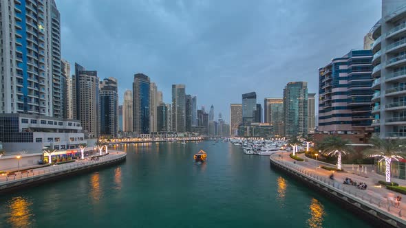 View of Dubai Marina Towers and Canal in Dubai Day to Night Timelapse