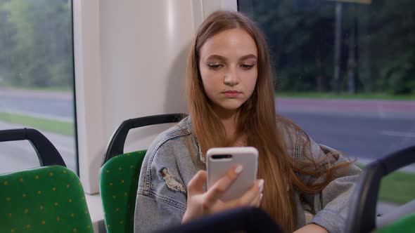 Woman Playing on Smartphone Chatting Texting Browsing Social Media While Traveling By Bus to City
