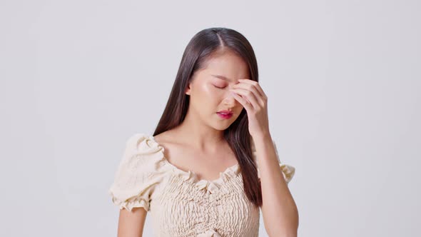 Asian woman have a headache and Migraine feeling so stressed isolated on white