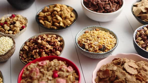 Assortment of Different Kinds Cereals Placed in Ceramic Bowls on Table