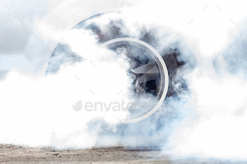 Close up car wheel with smoke on the asphalt road speed track, Car wheel drifting and smoking.