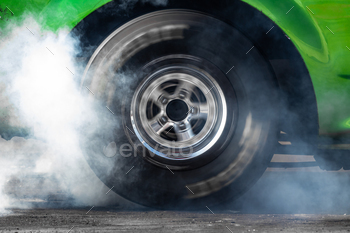 Close up car wheel with smoke on the asphalt road speed track, Car wheel drifting and smoking.