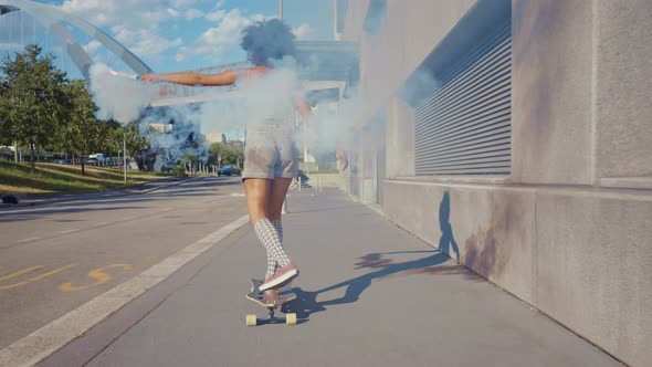 Beautiful young woman cruising around the city with her longboard.